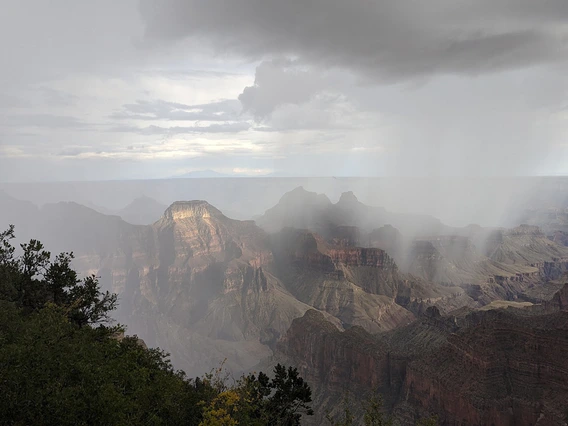 photo of the grand canyon with rain and clouds