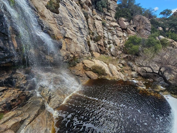 photo of a waterfall and small body of water