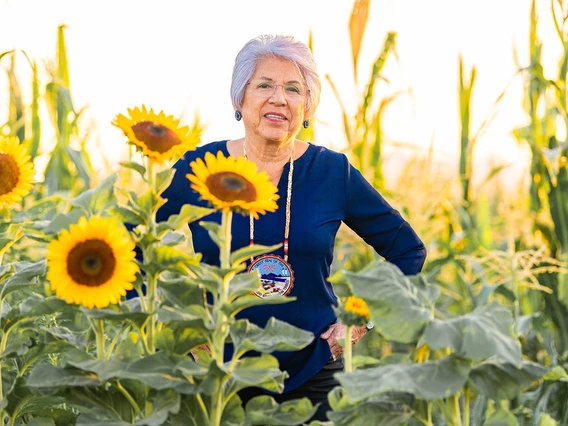 chairwoman flores in a field of sunflowers 