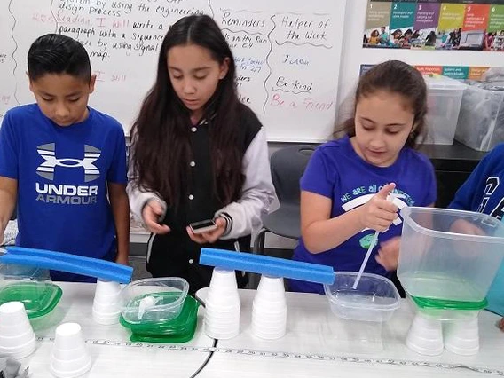 Children doing water experiment