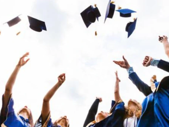 group of graduates throwing caps