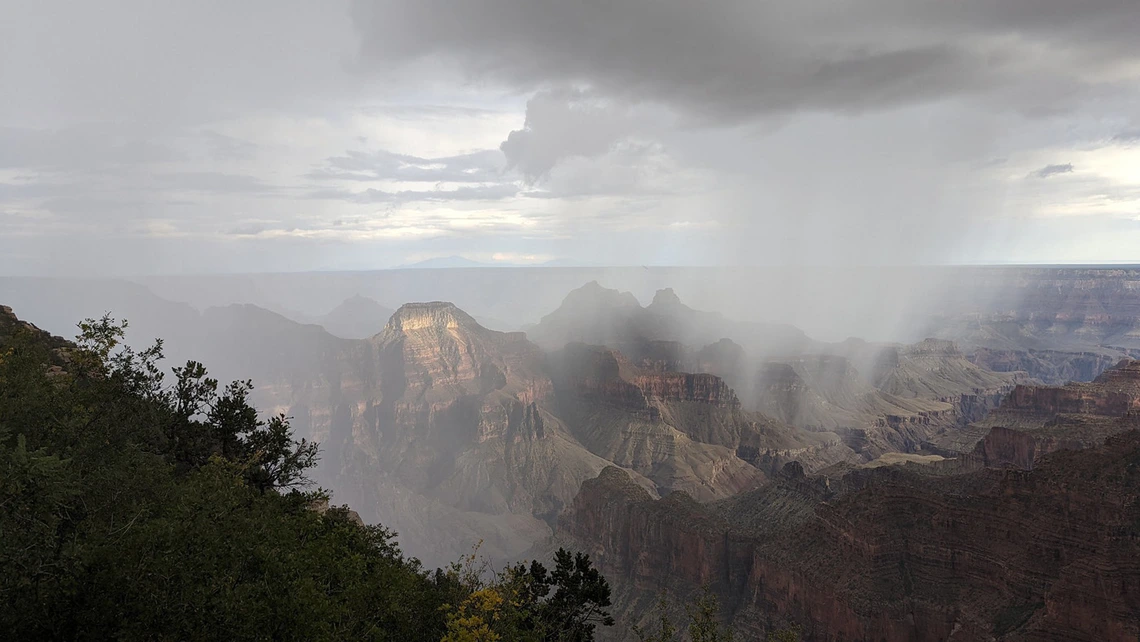 photo of the grand canyon with rain and clouds