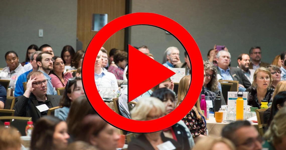 2019 Annual Conference Audience with a red play button overlaid 2019 Annual Conference Audience with a red play button overlaid