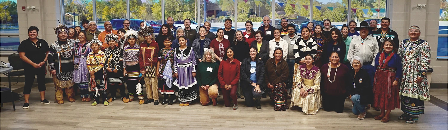 Chief Sherri-Lyn Hill (far left) with dancers and singers from the Six Nations of the Grand River and workshop participants.