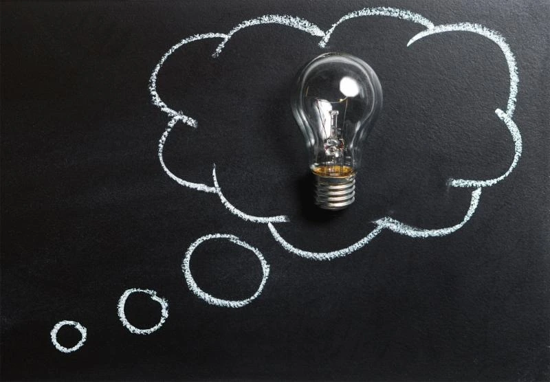 a chalk thought bubble around a lightbulb a chalk thought bubble around a lightbulb