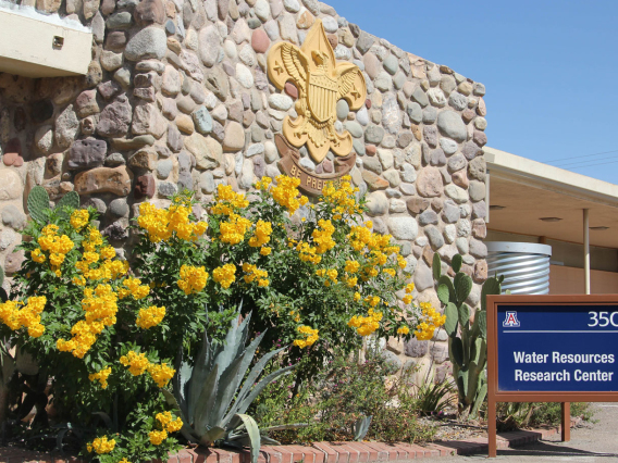 photo of the front of the WRRC featuring a blue sign and yellow flowers