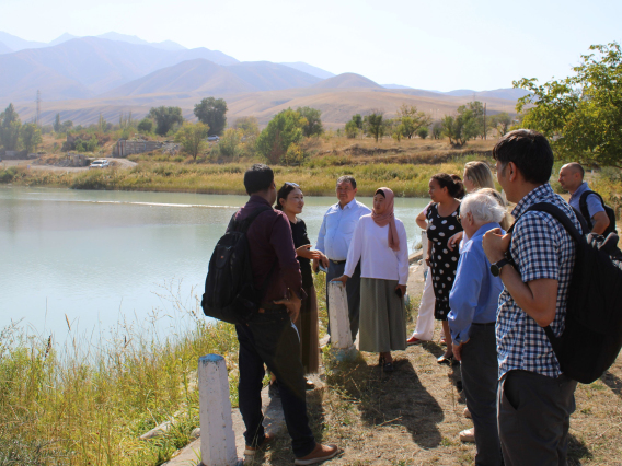 students standing near water