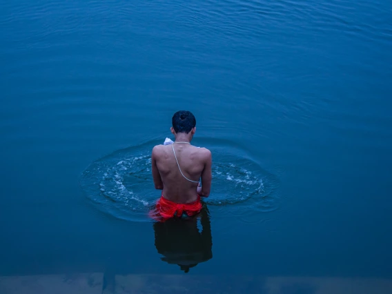 photo of a person standing in intense blue water