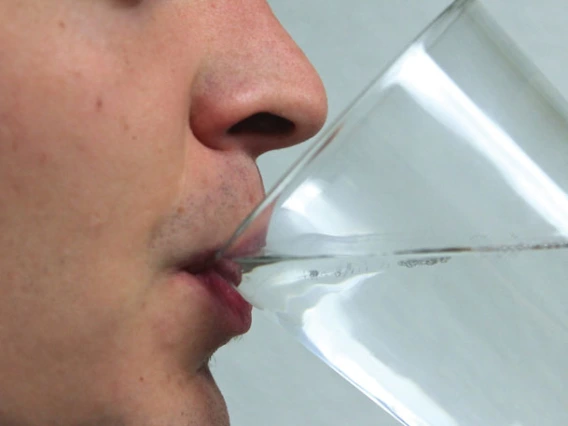 random guy drinking water out of a glass