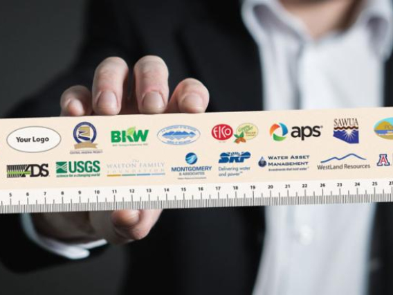 a hand holding a ruler with sponsor logos