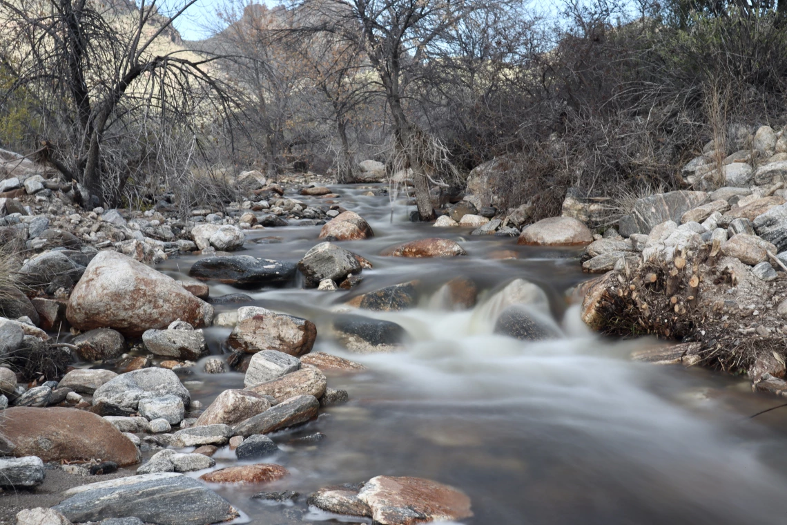 Carson Dimaria photo showing Bear Canyon Wash with water flowing through it. The motion of the water is captured by the photographer