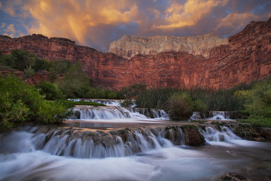 Dave Wilson photo showing motion in water at Havasu Creek; Grand canyon, AZ with red rocks in the background
