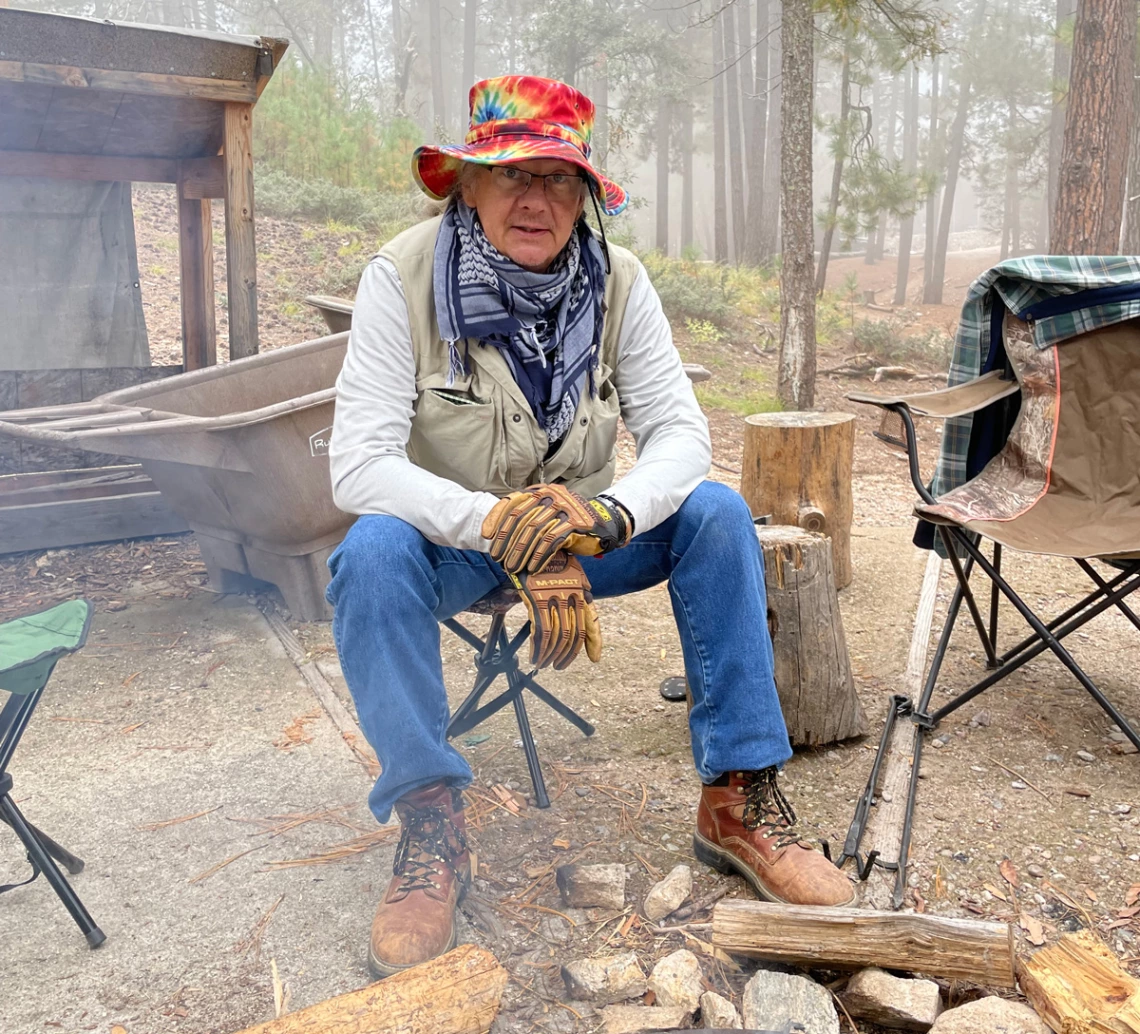 Josh Ruddick sitting by fire