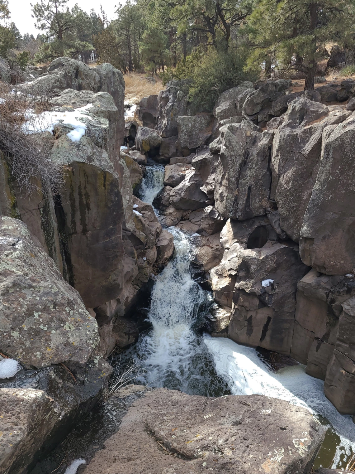 photo of a rocky canyon with a small waterfall