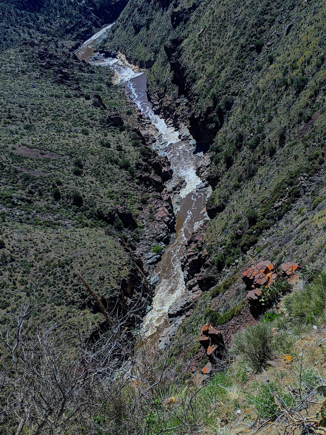 photo of a river cutting through a mountain valley