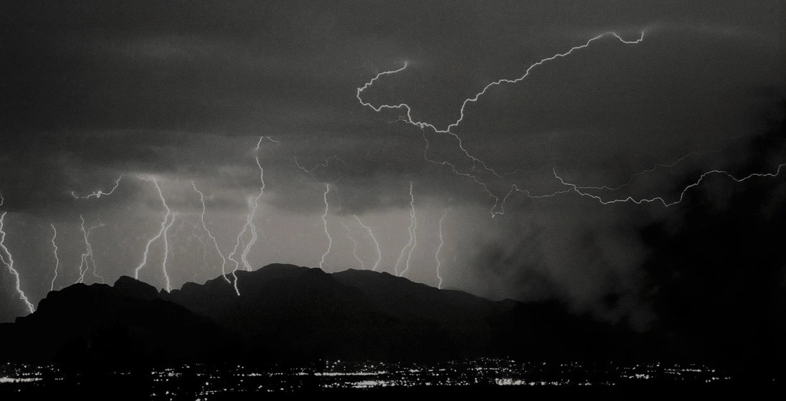 black and white photo showing multiple lightning bolts in Tucson