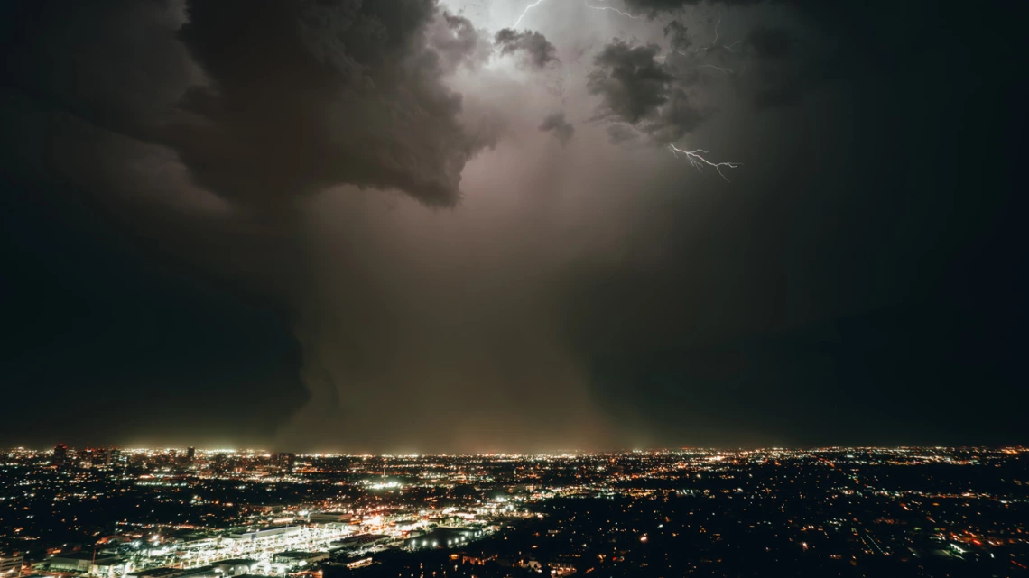 night photo of phoenix cityscape showing lightning storm 