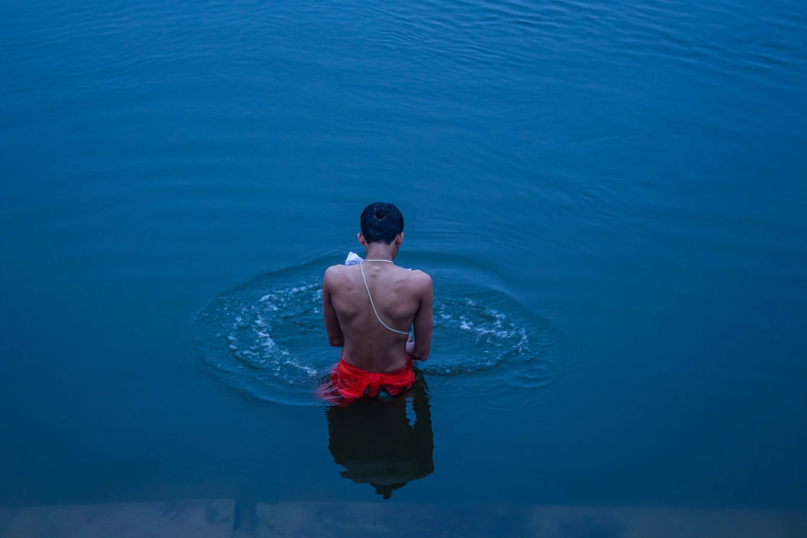 photo of a person standing in intense blue water