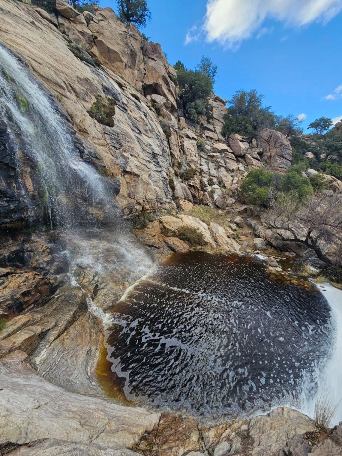 photo of a waterfall and small body of water