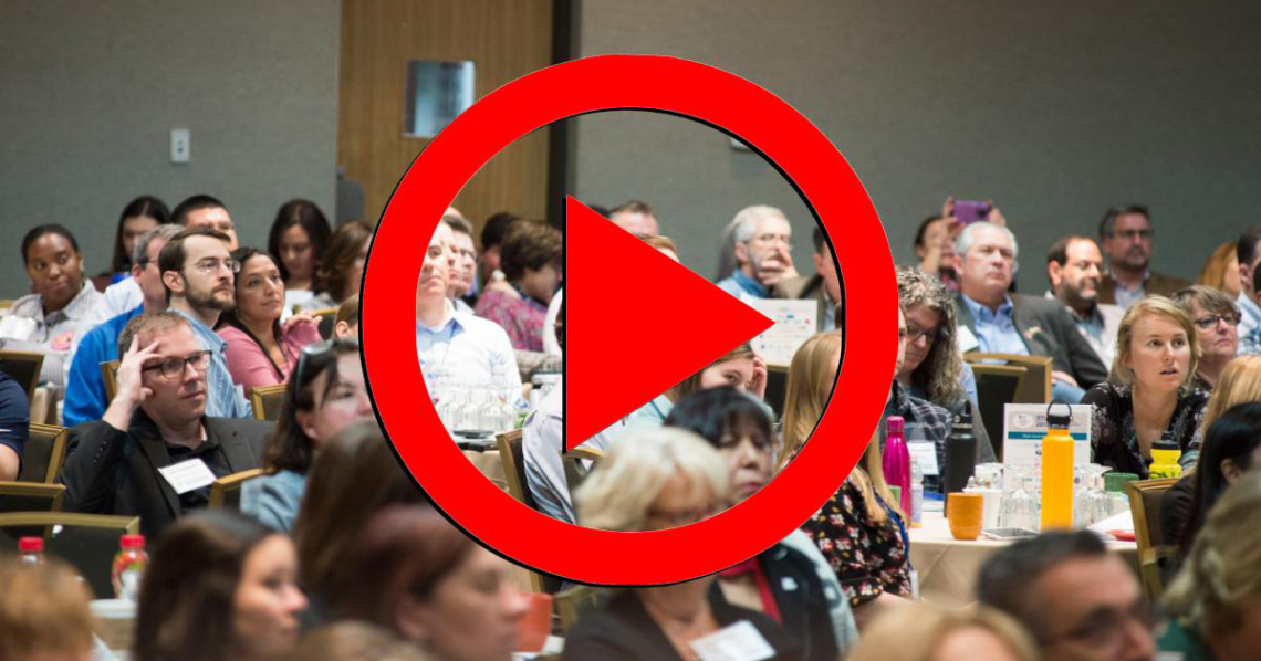 2019 Annual Conference Audience with a red play button overlaid