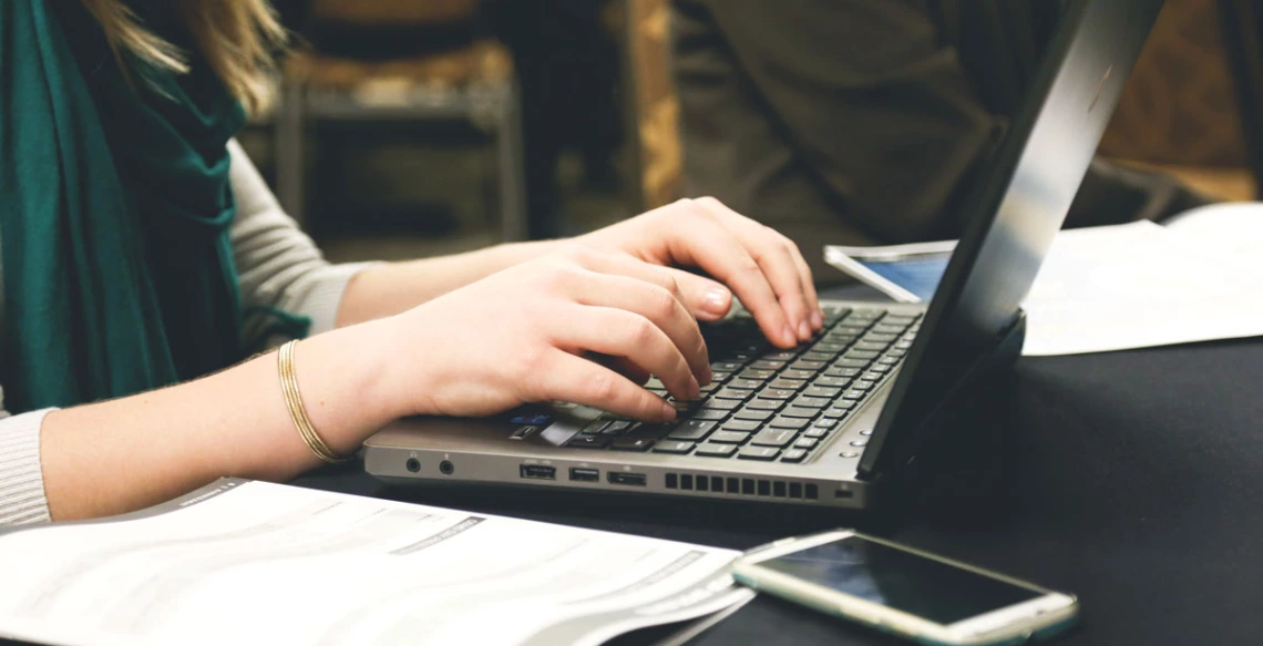 person typing at keyboard