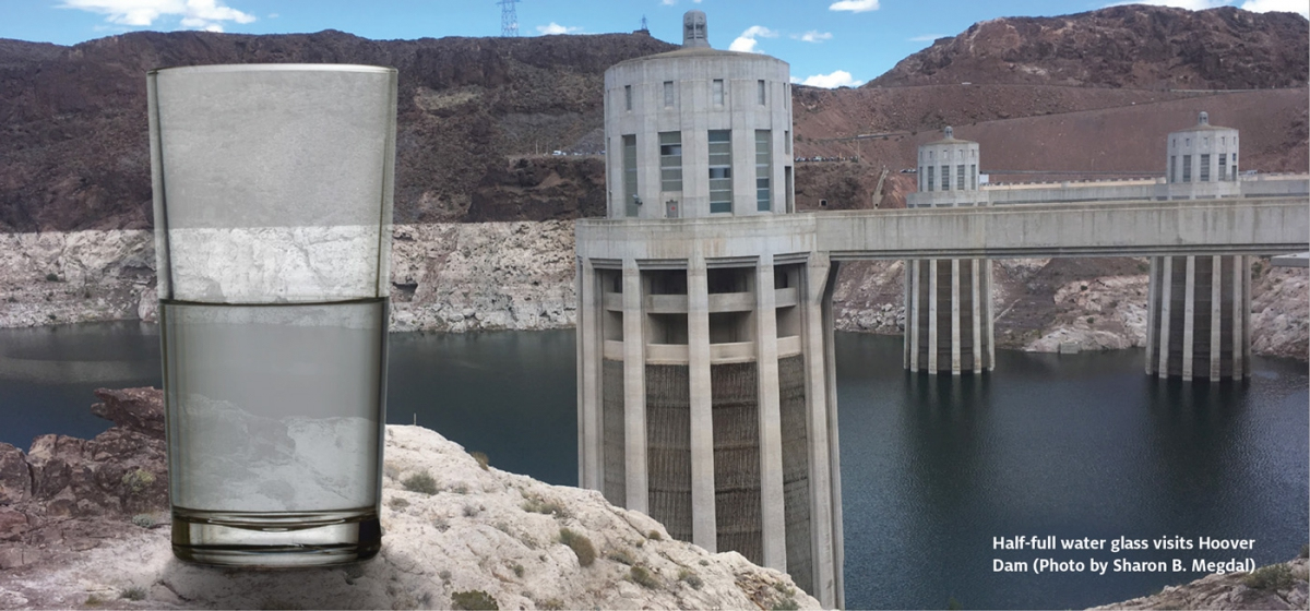 half glass of water in front of the hoover dam