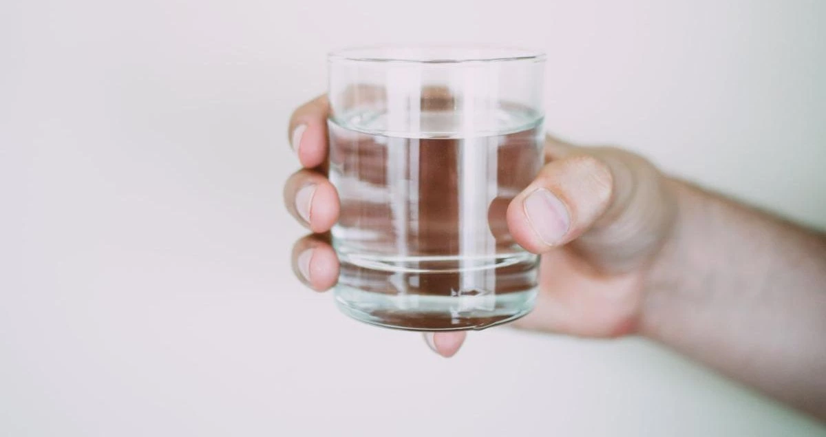 a hand holding a glass of water