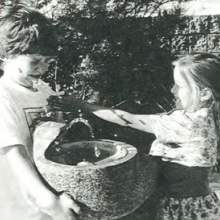 two children at drinking fountain